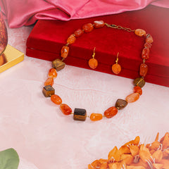 Eykaa brand set that has Tiger Eye and Leon Tumble semi precious stones beside red box, silky pink fabric and flowers
Eykaa
stone jewellery
womens jewellery
earing for women
bracelet for women
necklace for women
jewellery stores