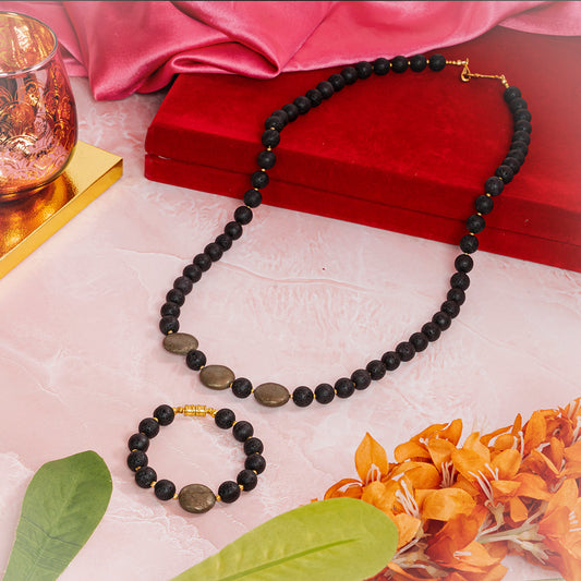 Eykaa necklace and bracelet that features lava with pyrite coins semi-precious stones displayed over a red jewellery box.