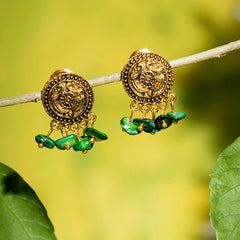 Eykaa brand green mother of pearl semi precious stone earrings with golden charms, hanging on a branch with green background.