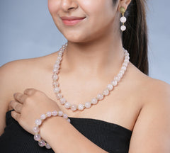 Girl model Wearing Eykaa Rose Quartz With Golden Diamond Charms Necklace With Earrings And A Bracelet.