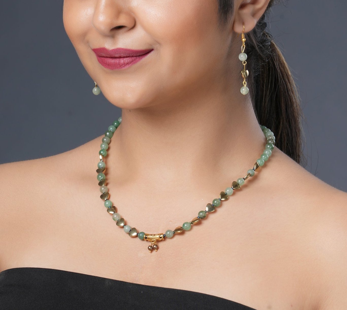 Girl model wearing Eykaa green aventurine, golden hematite and shell pearls semi precious stone necklace and earrings