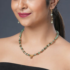 Girl model wearing Eykaa green aventurine, golden hematite and shell pearls semi precious stone necklace and earrings