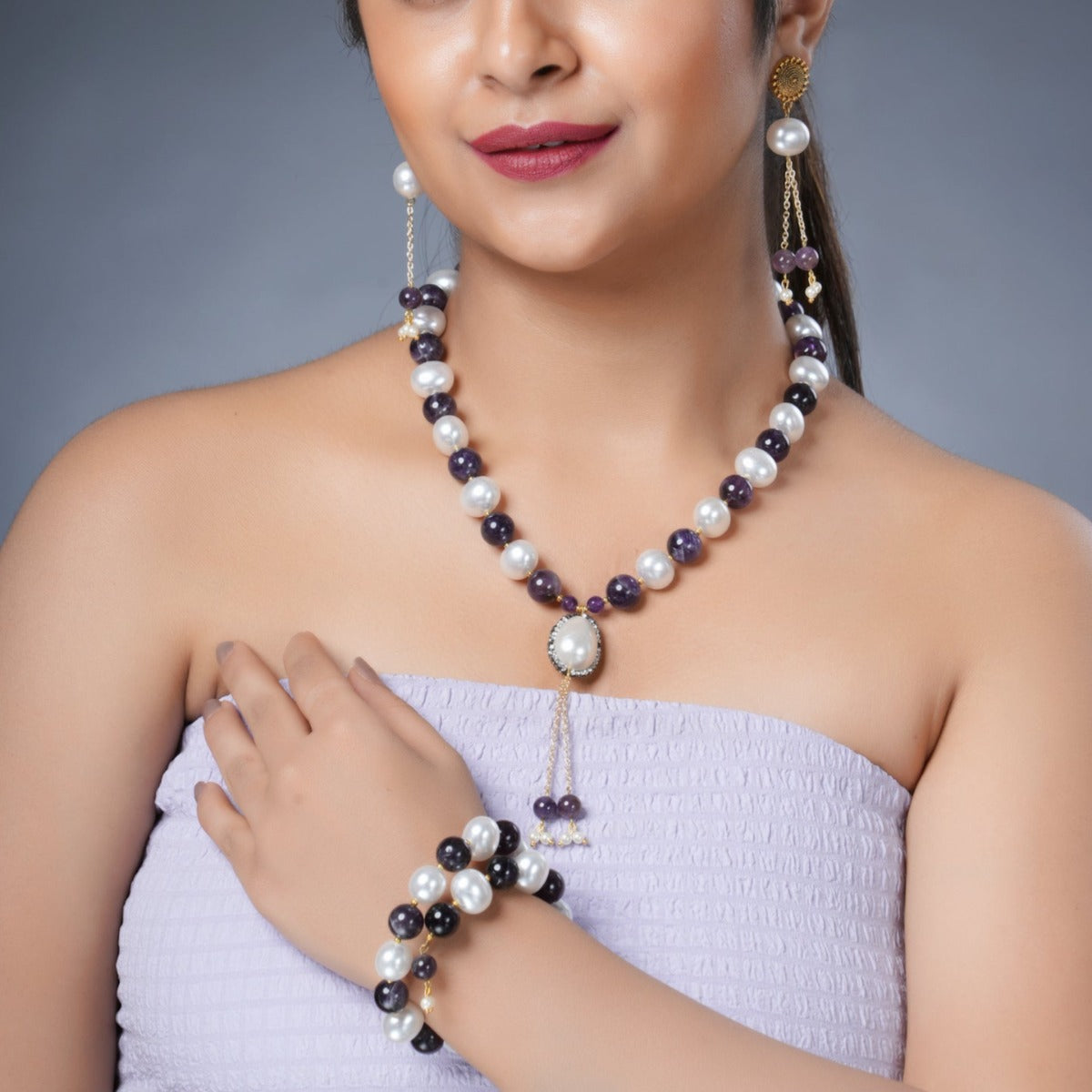 Girl Model Wearing Eykaa Amethyst With Korean Pearl Balls And Shell Pearl Necklace With Earrings And Bracelet.
Eykaa
stone jewellery
womens jewellery
earing for women
bracelet for women
necklace for women
jewellery stores
