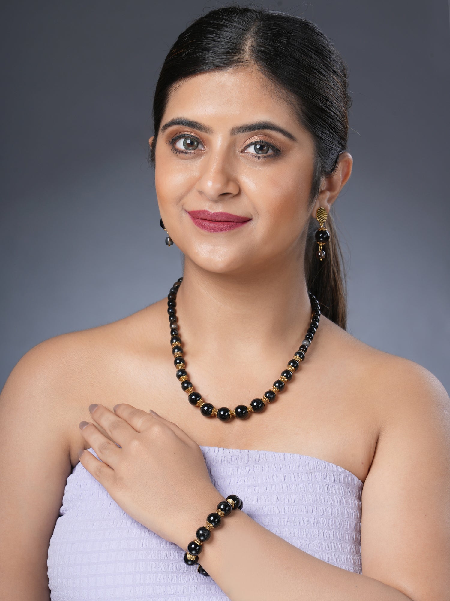 Girl model wearing Eykaa necklace, earrings and bracelet featuring black tourmaline, blackonyx and hakik semi precious stone
Eykaa
stone jewellery
womens jewellery
earing for women
bracelet for women
necklace for women
jewellery stores
