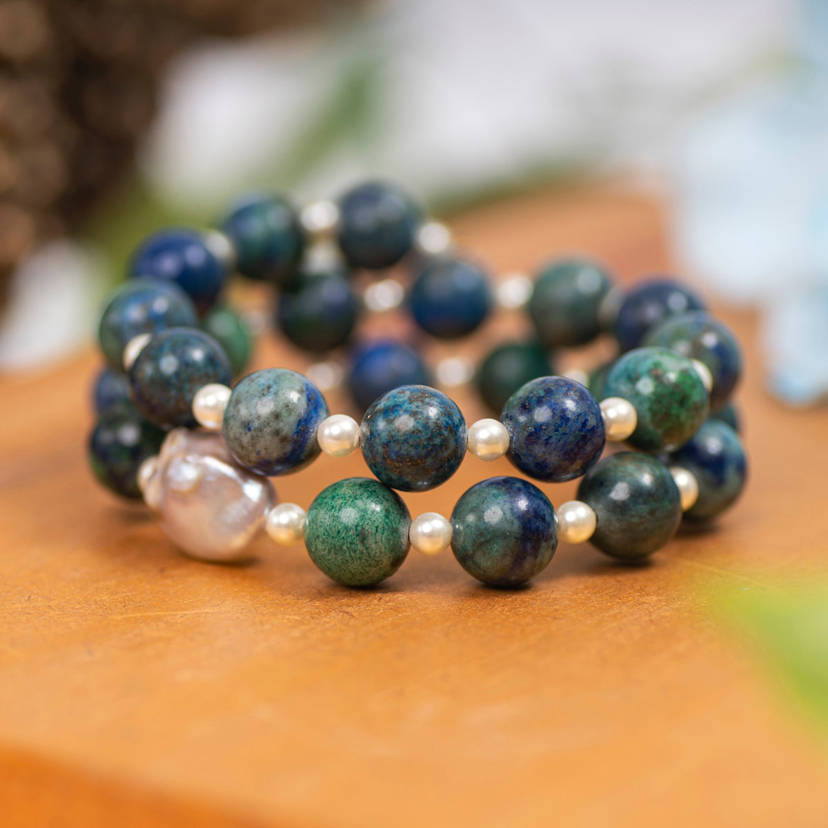 Eykaa Azurite And Freshwater Pearl Bracelet Displayed On A Textured Orange Surface.
Eykaa
stone jewellery
womens jewellery
earing for women
bracelet for women
necklace for women
jewellery stores