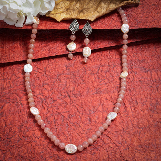 Eykaa Strawberry Quartz And Freshwater Pearl Necklace With Earrings On A Textured Red Background With White Flowers. 
Eykaa
stone jewellery
womens jewellery
earing for women
bracelet for women
necklace for women
jewellery stores
