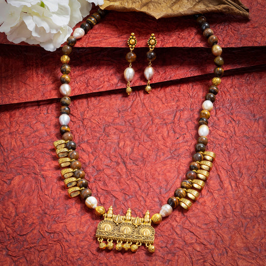 Eykaa Freshwater Pearl And Tiger Eye Necklace With Earrings On A Textured Red Background With White Flowers.
Eykaa
stone jewellery
womens jewellery
earing for women
bracelet for women
necklace for women
jewellery stores