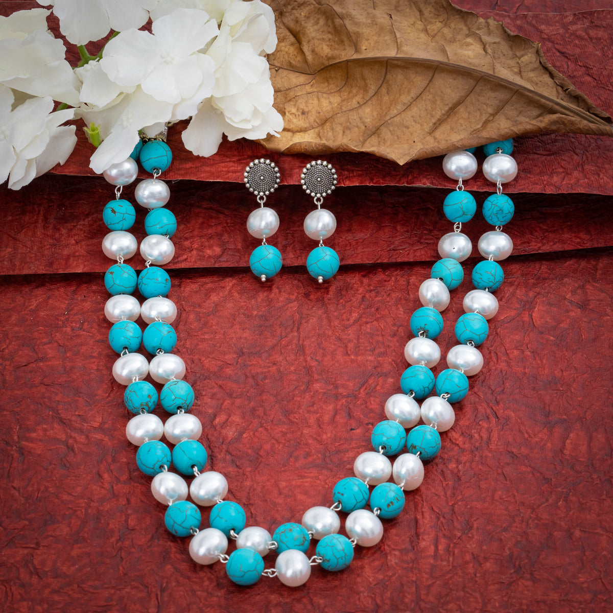 Eykaa Firoza With Korean Pearl Balls Layered Necklace With Earrings On A Textured Red Background With White Flowers.
Eykaa
stone jewellery
womens jewellery
earing for women
bracelet for women
necklace for women
jewellery stores