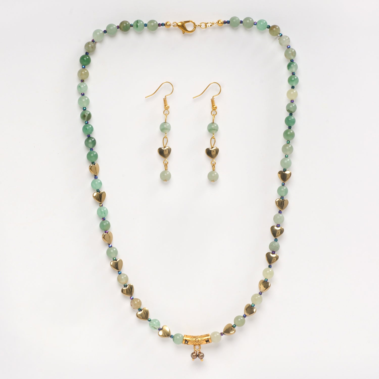 Eykaa green aventurine, golden hematite and shell pearls semi precious stone necklace and earrings on white background.