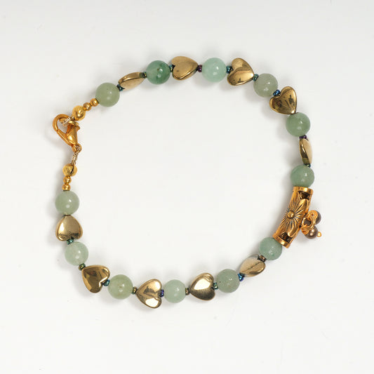 Eykaa green aventurine, golden hematite with golden charms and shell pearls semi precious stone bracelet on white background.