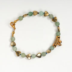 Eykaa green aventurine, golden hematite with golden charms and shell pearls semi precious stone bracelet on white background.