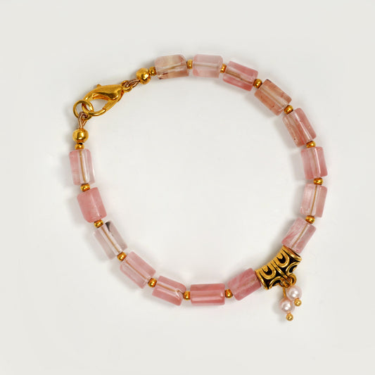 Eykaa cherry quartz with golden charms and shell pearls semi precious stone bracelet on a white background.