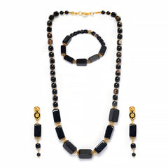 Eykaa brand necklace, bracelet and earrings that feature semi precious stone black onyx with hakik on a white background. 