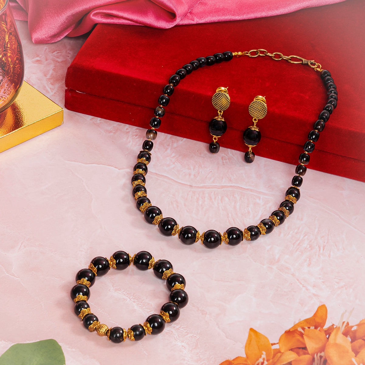 Eykaa jewelry set featuring black tourmaline, black onyx and hakik semi precious stone beside red box, pink cloth and flower

Eykaa
stone jewellery
womens jewellery
earing for women
bracelet for women
necklace for women
jewellery stores