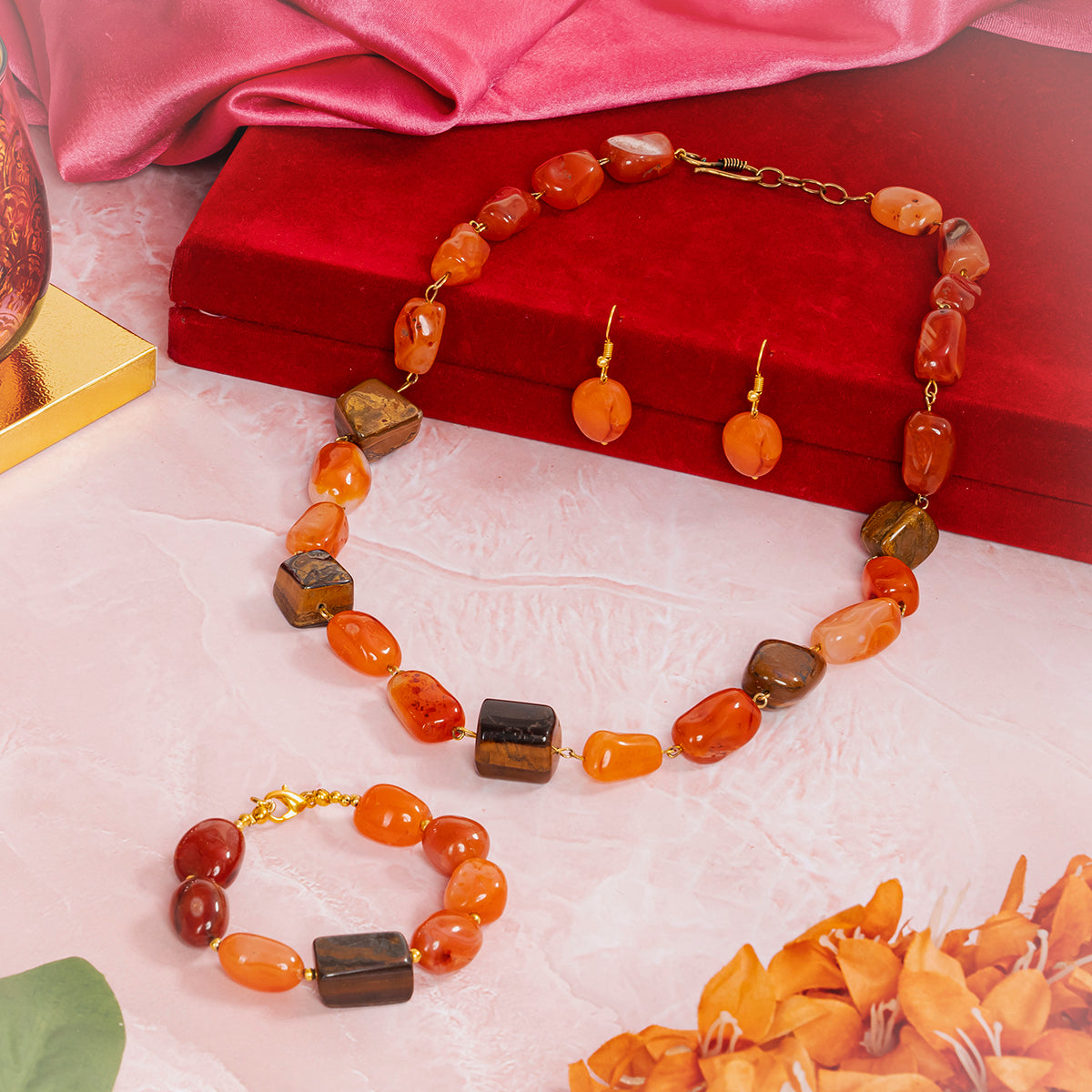 Eykaa jewelry set that features leon with tiger eye semi precious stones beside red box, silky pink fabric, and flowers

Eykaa
stone jewellery
womens jewellery
earing for women
bracelet for women
necklace for women
jewellery stores