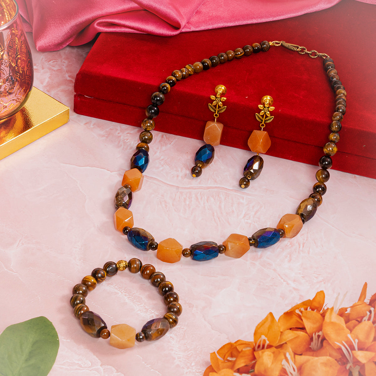 Eykaa jewelry set that have tiger eye, hematite with carnelian semi precious stones, red box, silky pink fabric and flowers