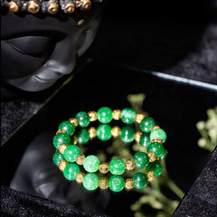 Eykaa EYKAA GREEN JADE WITH SHELL PEARLS WITH GOLDEN BEADS BRACELET with black background beside silver lace.