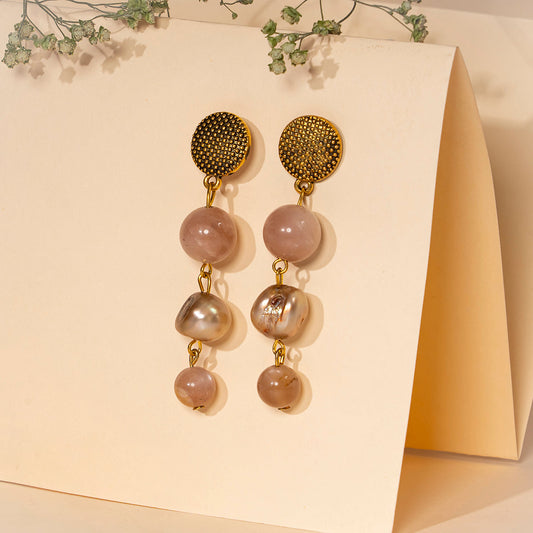 Eykaa peach moonstone, freshwater pearl and shell pearls semi precious stone earrings over cream colour background