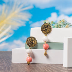 Eykaa Marble, Coral And Bamboo Coral Necklace Earrings Displayed On Multi-tiered Platform With Sky And Clouds Background.