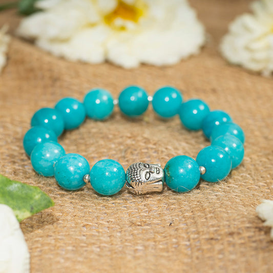 EYKAA BLUE JADE BRACELET on sack surface with white flowers.