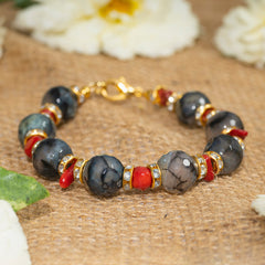 Eykaa Agate With Coral Bracelet On Sack Surface With White Flowers.