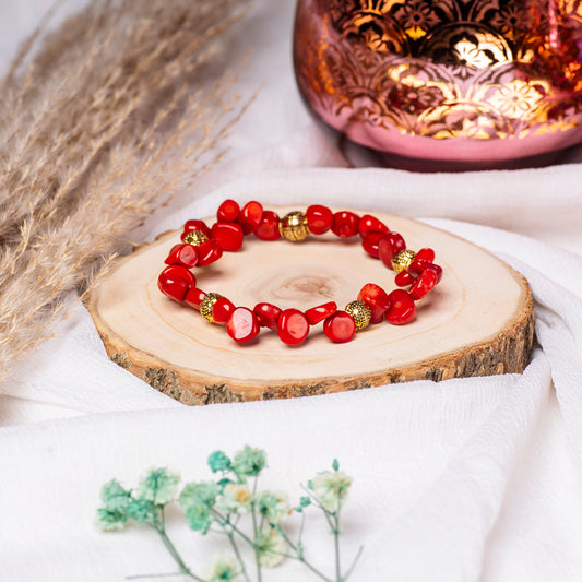 Eykaa White and Red Coral with Golden Beads Bracelet On A Rustic Wooden Slice.