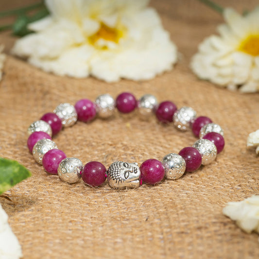 Eykaa brand bracelet that feature silver lava and jade semi precious stone on a sack surface with white flowers.