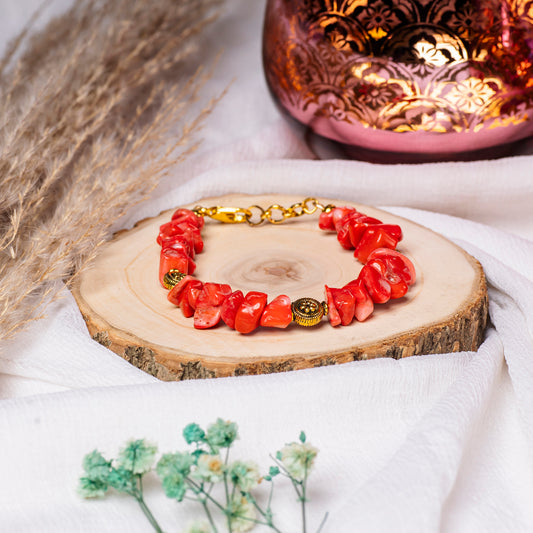 Eykaa Pure Coral Bracelet Earrings And Bracelet On A Vibrant Red Surface.