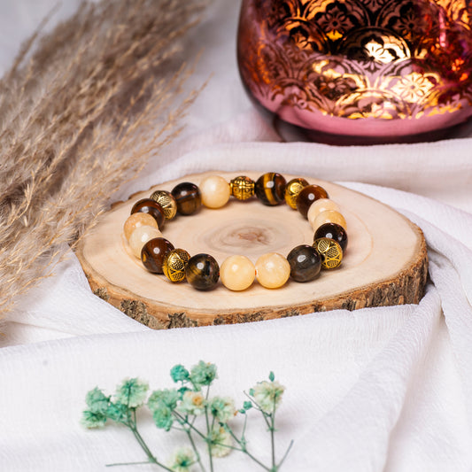 Eykaa  Tiger Eye, Yellow Calcite And Red Onyx With Yellow Aventurine Bracelet On A Rustic Wooden Slice.