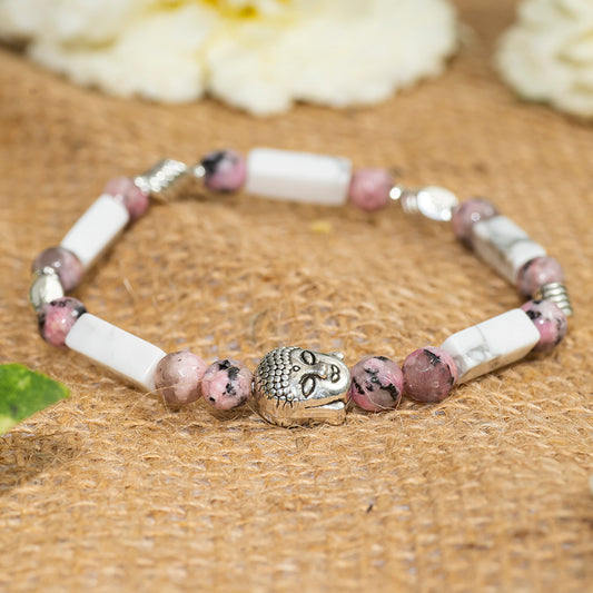 Eykaa white howlite with dalmatian and silver charms semi precious stone bracelet on sack surface background.