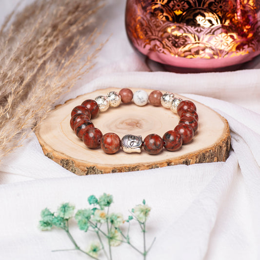   Eykaa Red Jasper And Silver Lava With White Howlite Bracelet On A Rustic Wooden Slice.