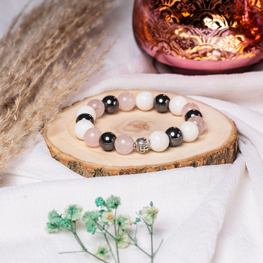 Eykaa Rose Quartz, Hematite And  Marble With Firoza Bracelet On A Rustic Wooden Slice.