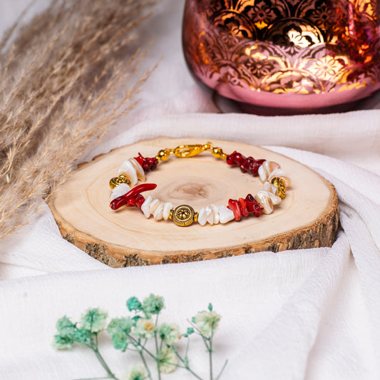 Eykaa White Mother Of Pearl And Coral Bracelet On A Rustic Wooden Slice.