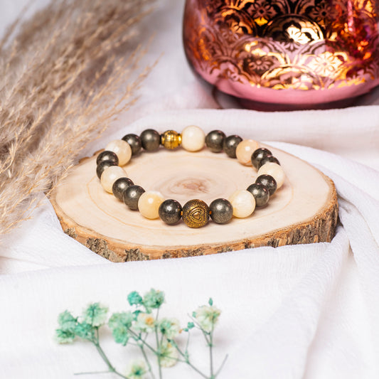 Eykaa Yellow Calcite And Pyrite, With Jasper Bracelet On A Rustic Wooden Slice.