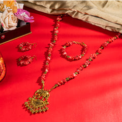 Eykaa Pure Coral Necklace With Earrings And Bracelet On A Vibrant Red Surface.