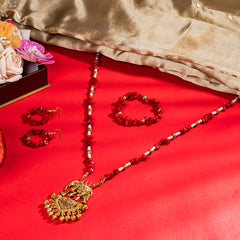 Eykaa White And Red Coral Necklace With Golden Beads Earrings And Bracelet On A Vibrant Red Surface.