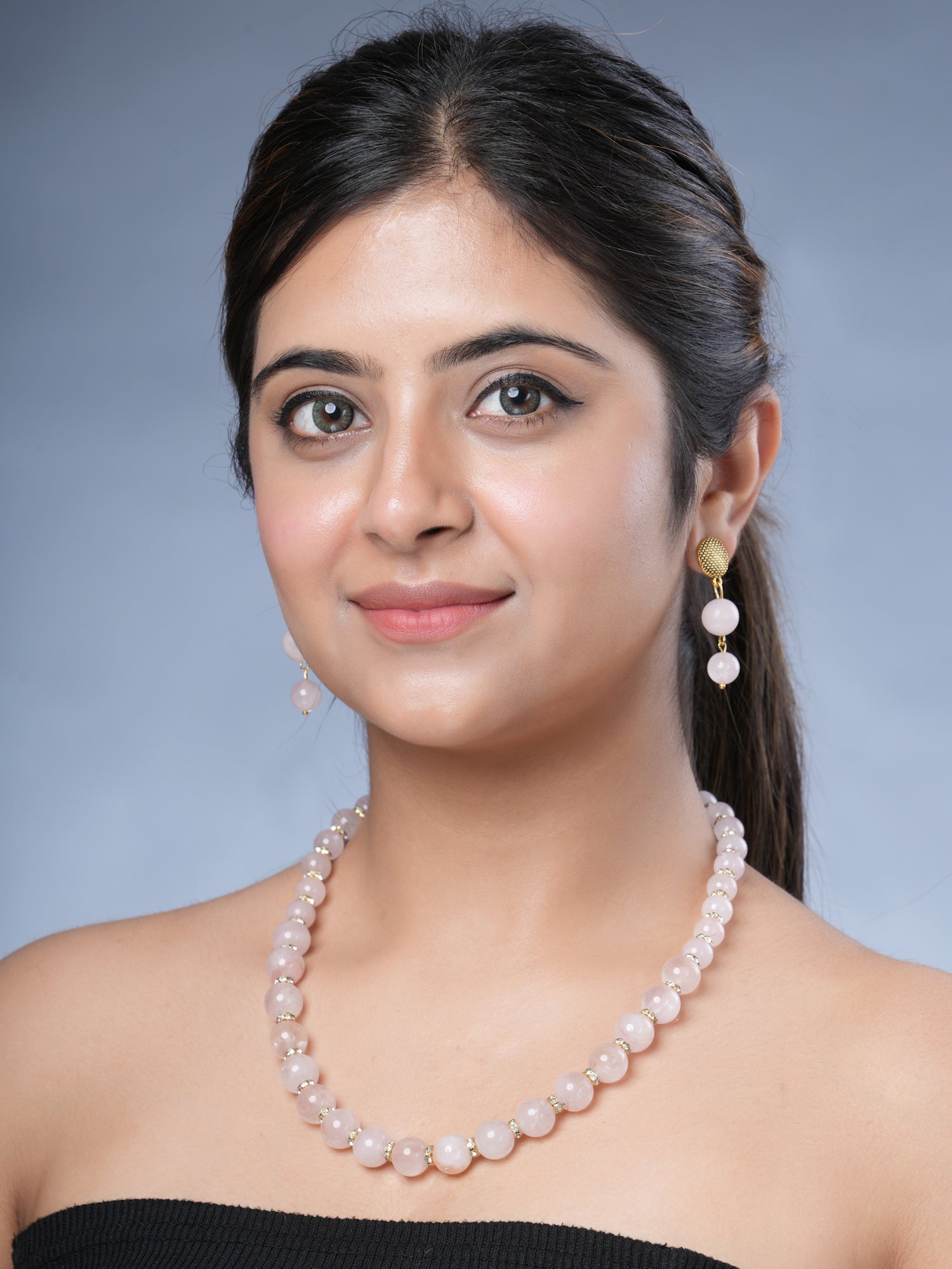 Girl model Wearing Eykaa Rose Quartz With Golden Diamond Charms Necklace With Earrings.