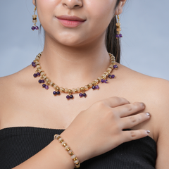 Girl model wearing Eykaa yellow calcedonia, jade, and golden hematite semi precious stone necklace, earrings and bracelet.