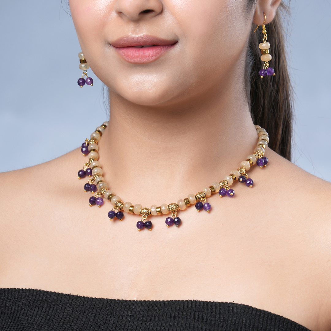 Girl model wearing Eykaa yellow calcedonia, purple jade, and golden hematite semi precious stone necklace and earring. 