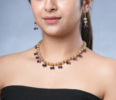 Girl model wearing Eykaa yellow calcedonia, purple jade, and golden hematite semi precious stone necklace and earring.