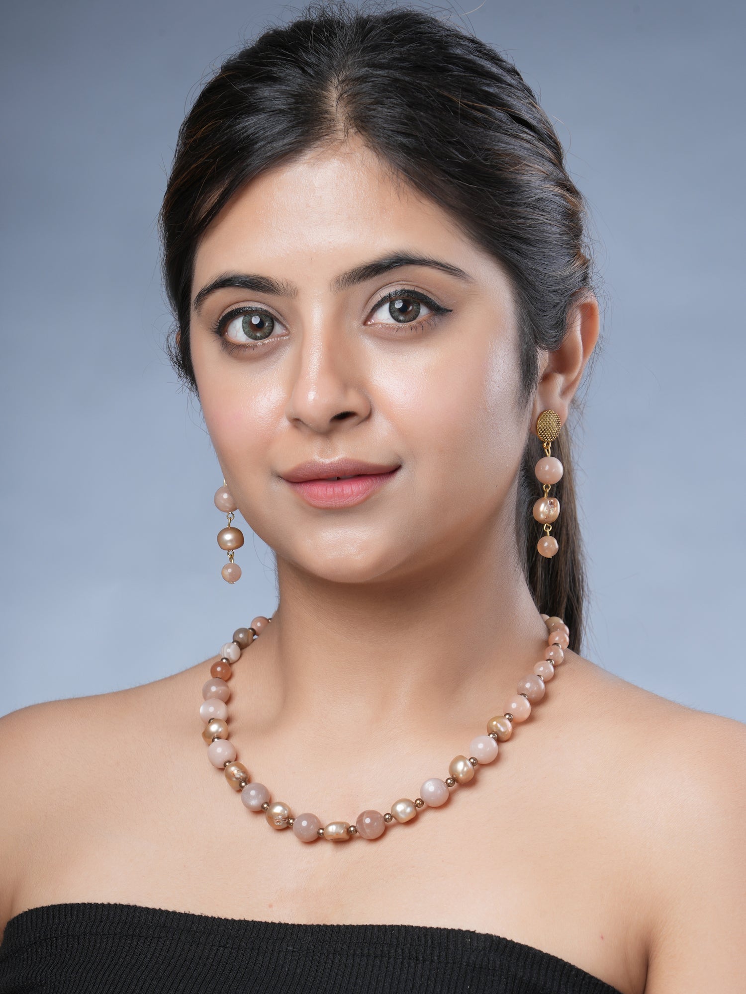 Girl model wearing Eykaa peach moonstone, freshwater pearl and shell pearls semi-precious stone necklace and earrings 