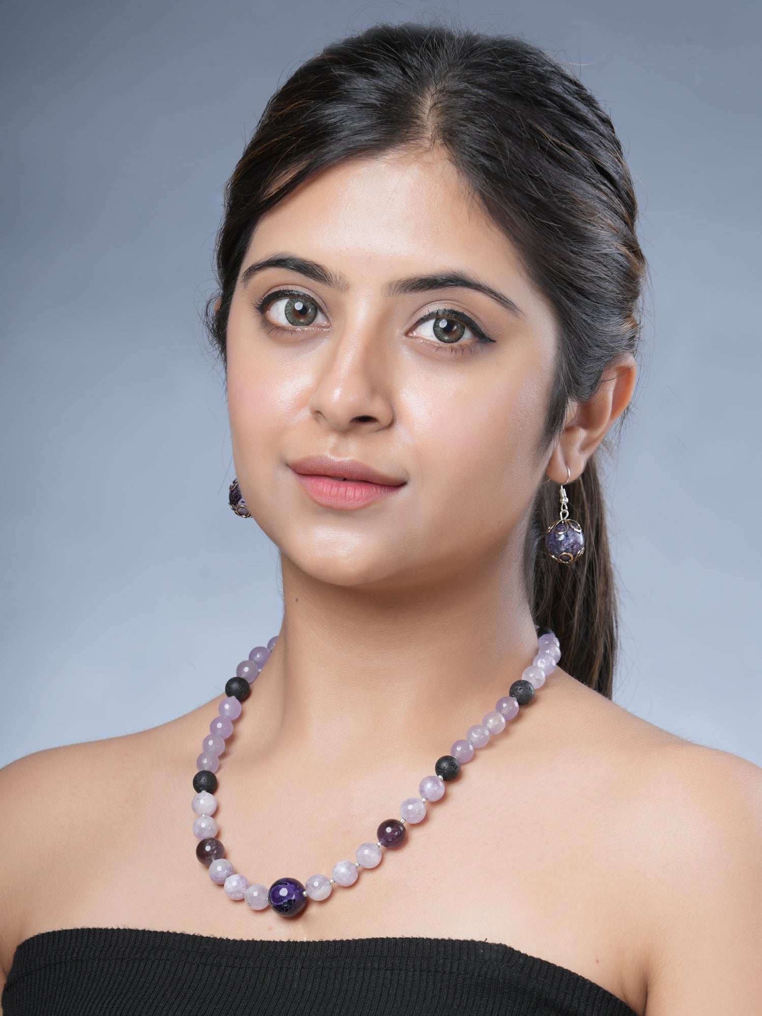 Girl model wearing Eykaa necklace and earrings that feature semi precious stone jade, kunzite and amethyst with silver bead