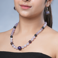 Girl model wearing Eykaa necklace and earrings that feature semi precious stone jade, kunzite and amethyst with silver bead