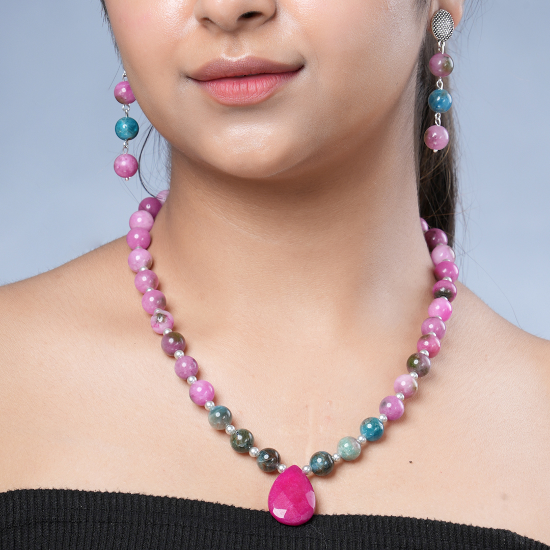 Girl model wearing Eykaa necklace and earrings that feature pink jade, blue apatite with pink agate semi precious stones