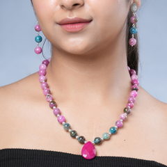 Girl model wearing Eykaa necklace and earrings that feature pink jade, blue apatite with pink agate semi precious stones