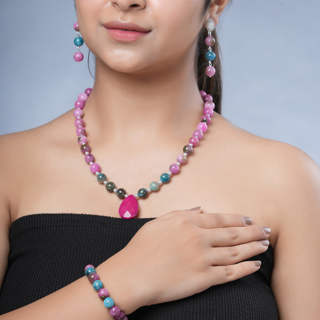 Girl model wearing Eykaa necklace, earrings and bracelet that have  pink jade, blue apatite with agate semi precious stones