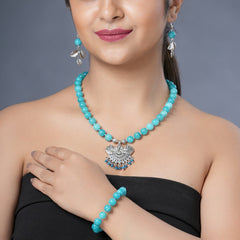 Girl model wearing Eykaa necklace, earrings and bracelet that features EYKAA BLUE JADE BRACELET