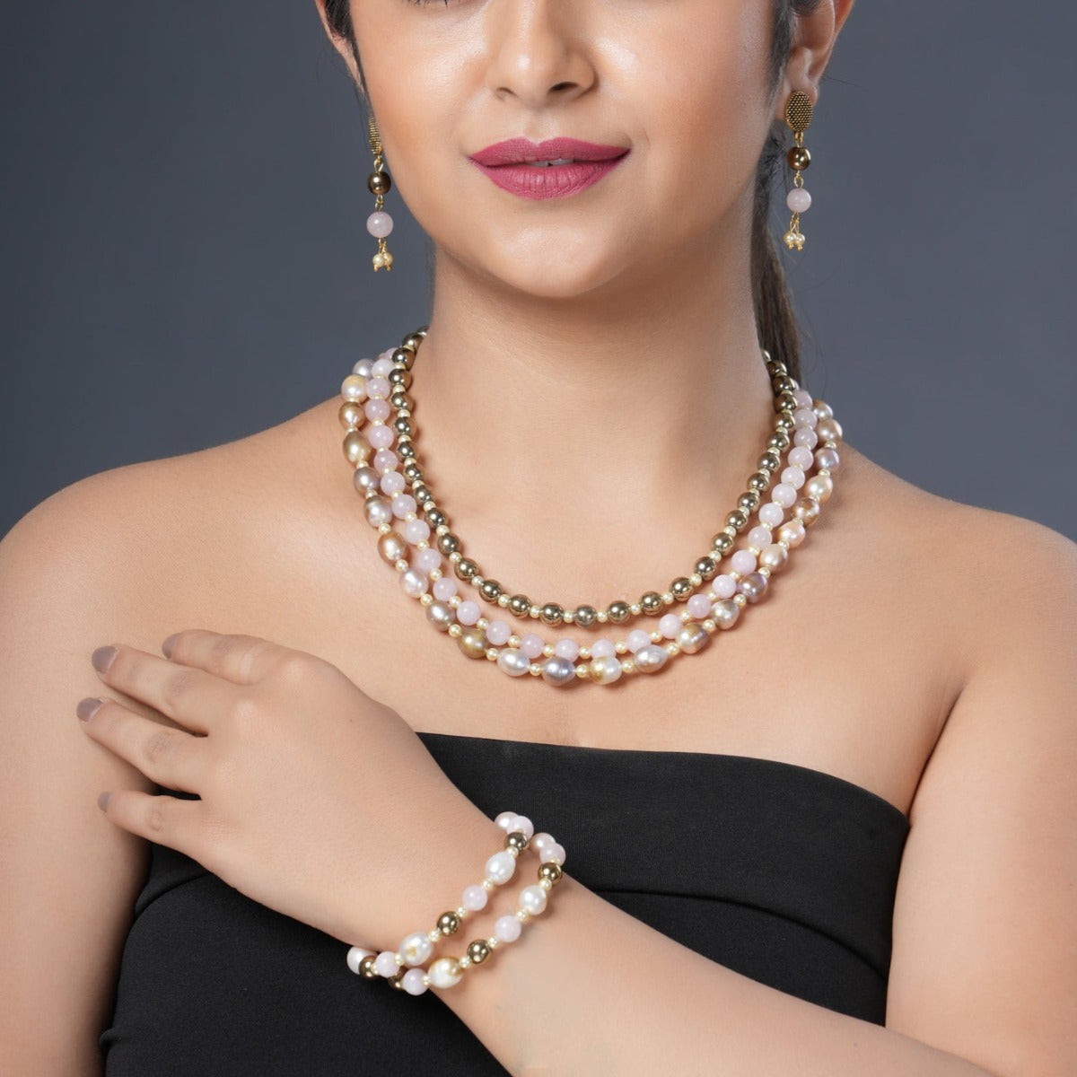 Girl Model Wearing Eykaa Layered Hematite, Rose Quartz, Freshwater Pearl, And Shell Pearl Necklace With Earrings And A Bracelet.