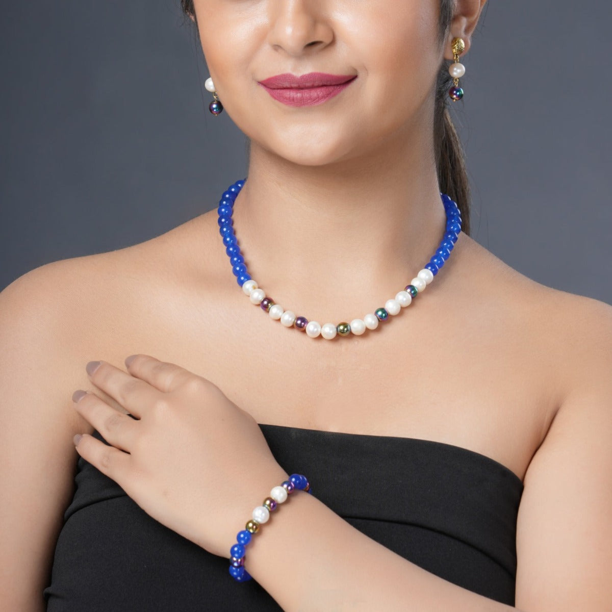 Girl Model Wearing Eykaa Blue Onyx, Rainbow Hematite, And Freshwater Pearl Necklace With Earrings And Bracelet.