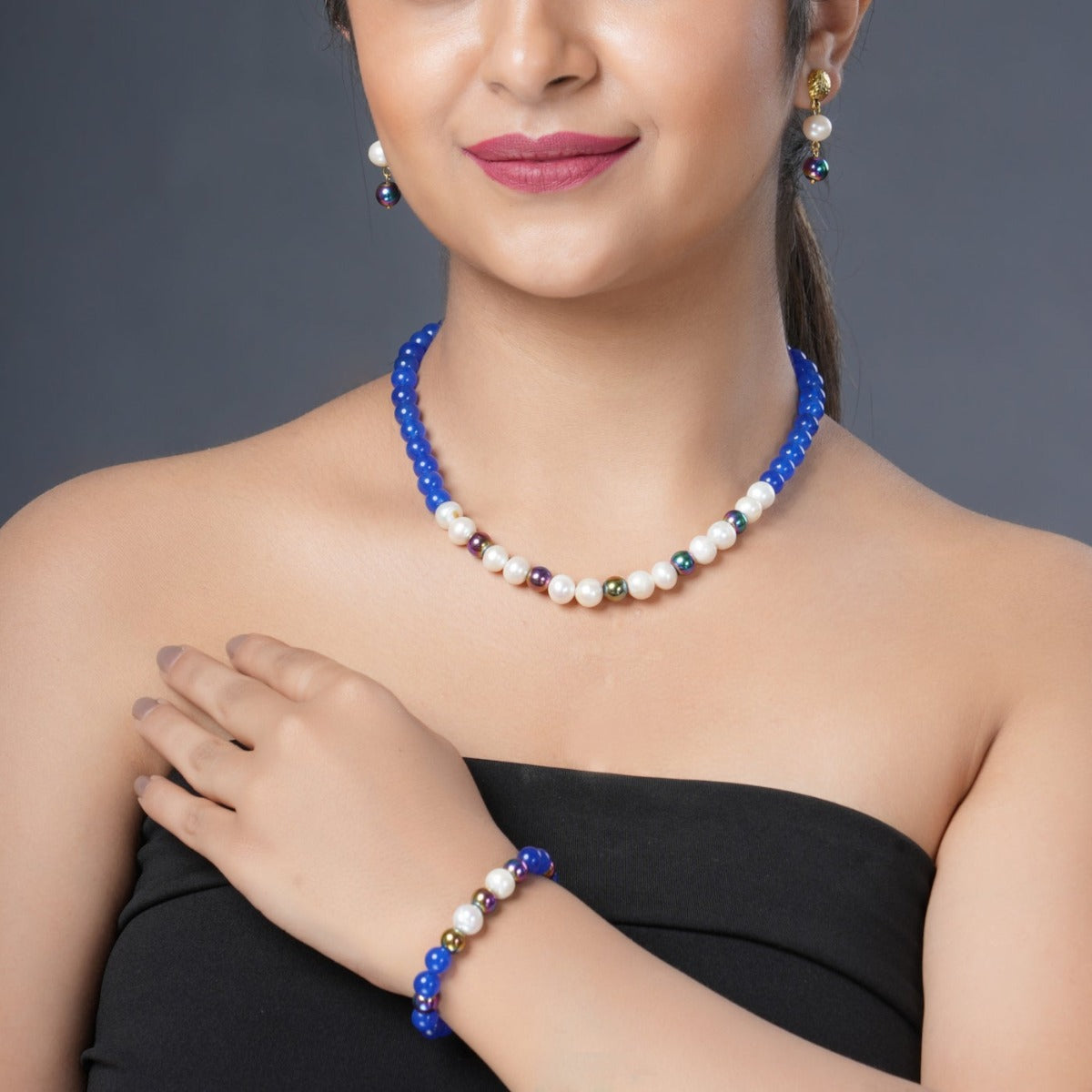 Girl Model Wearing Eykaa Blue Onyx, Rainbow Hematite, And Freshwater Pearl Necklace With Earrings And Bracelet.